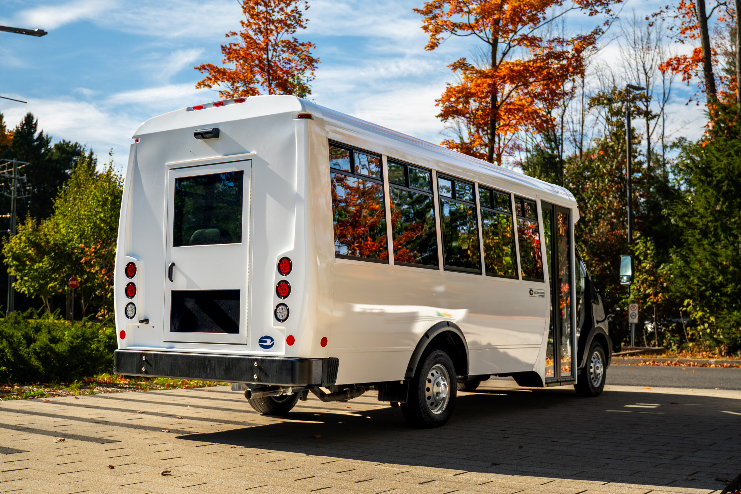 Micro Bird CT-Series commercial bus driving on a scenic fall road