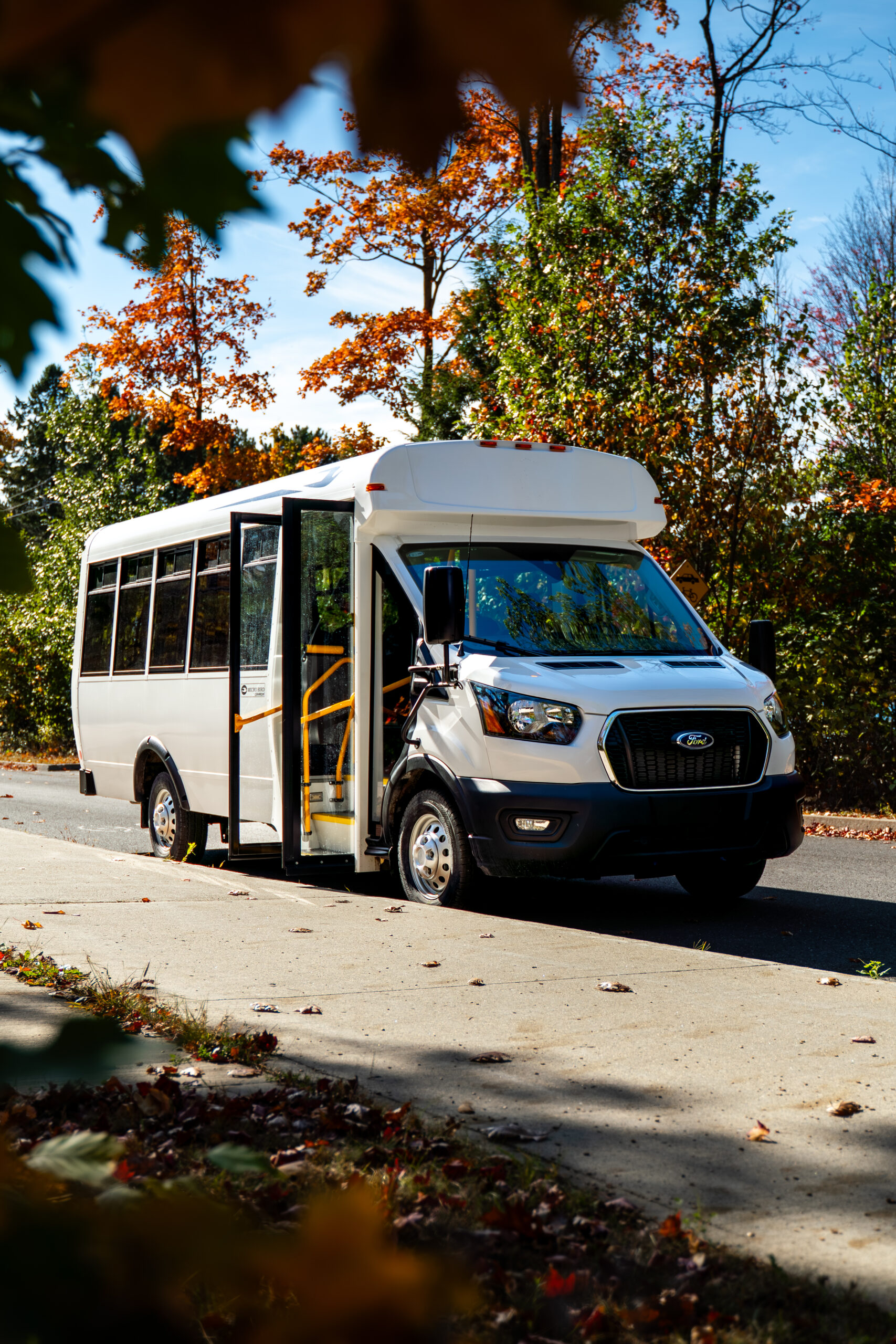 Micro Bird CT-Series commercial bus driving on a fall road